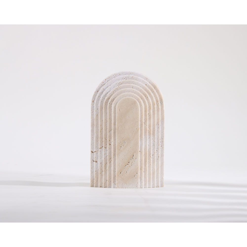 Beige travertine arch sculpture
