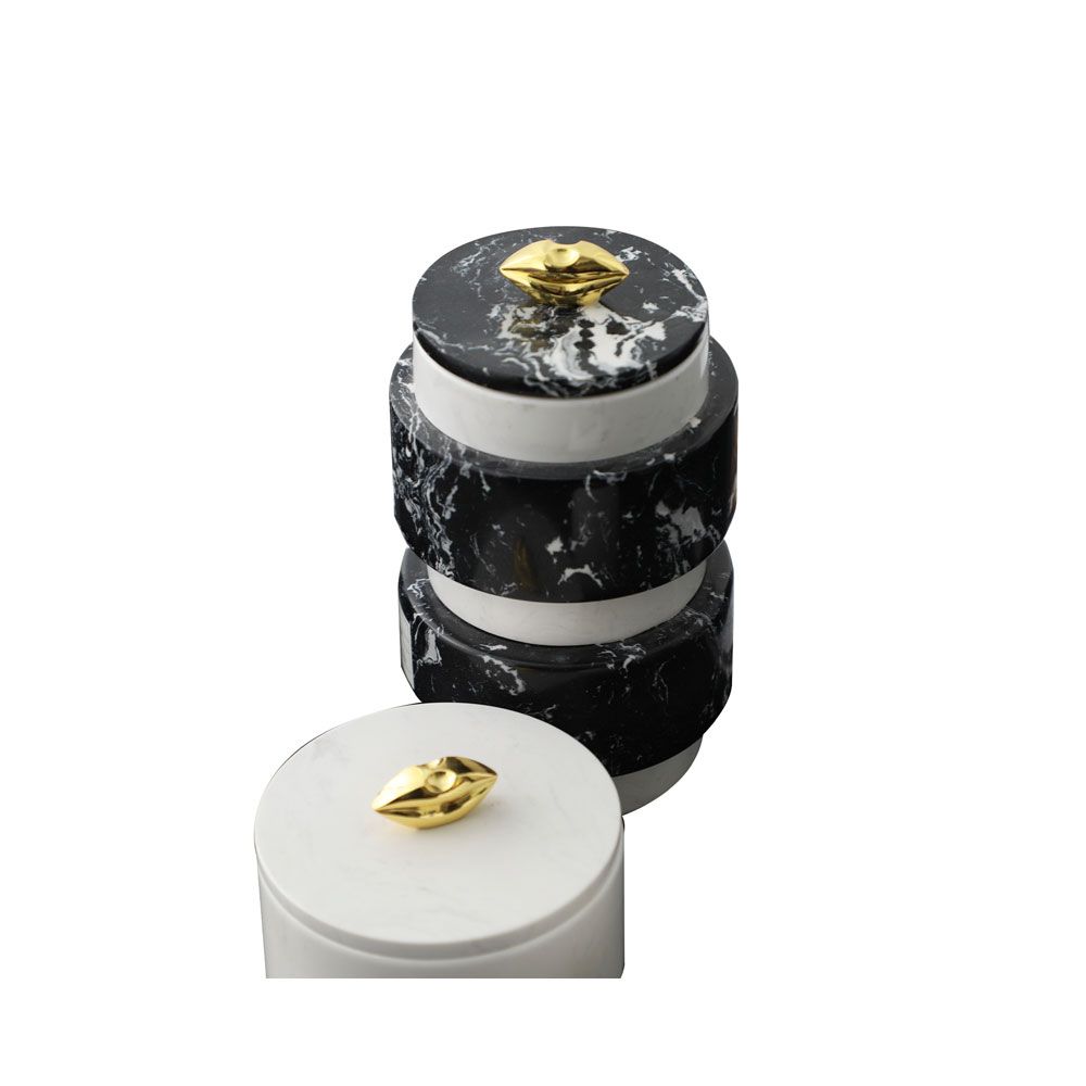 Stacked black and white marble cylinder with gold handle on the lid