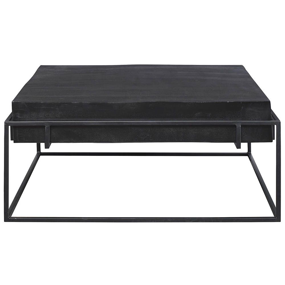 Bold black coffee table with thick surface suspended over minimal black legs