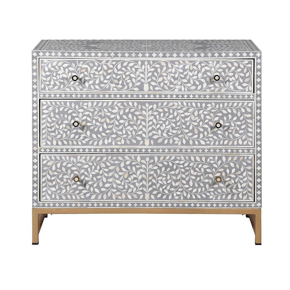 A gorgeous bone inlay chest of drawers with a stainless steel base 