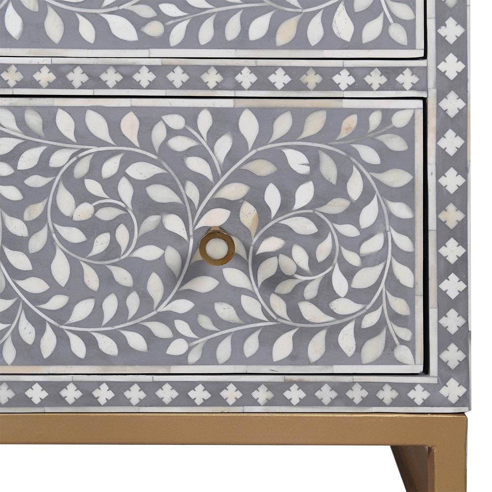 A gorgeous bone inlay chest of drawers with a stainless steel base 