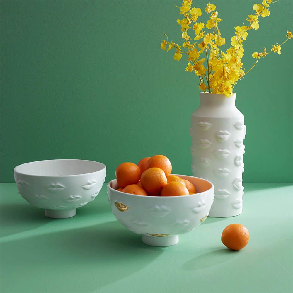 White bowl with lips detail and gold accents
