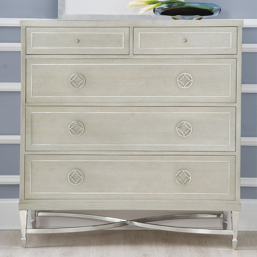 A luxurious chest of drawers from Bernhardt with an ash veneer and nickel finish, a stainless steel metal inlay and five spacious drawers