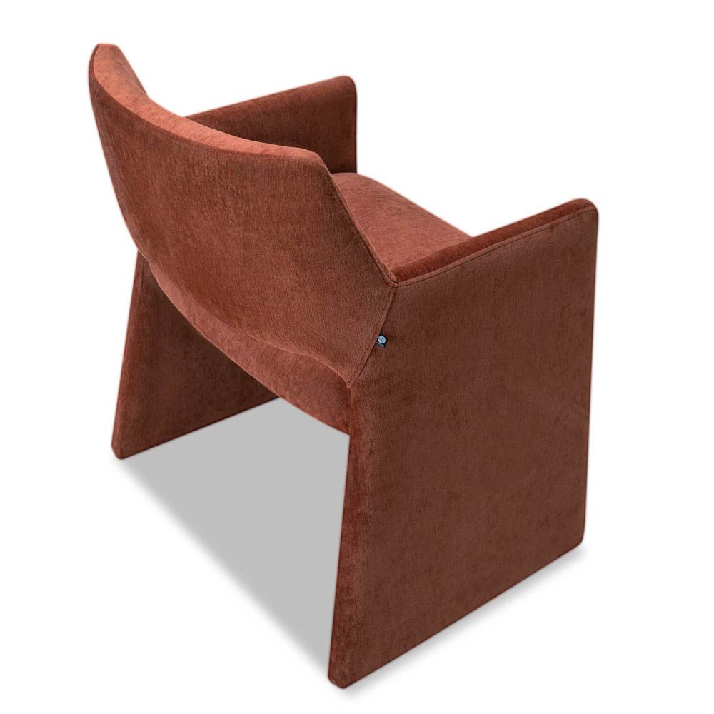 Rust dining chair with large tapered legs and wrap-around back