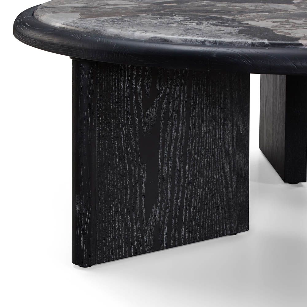 Round coffee table with grey marble top and matte black ash veneer base