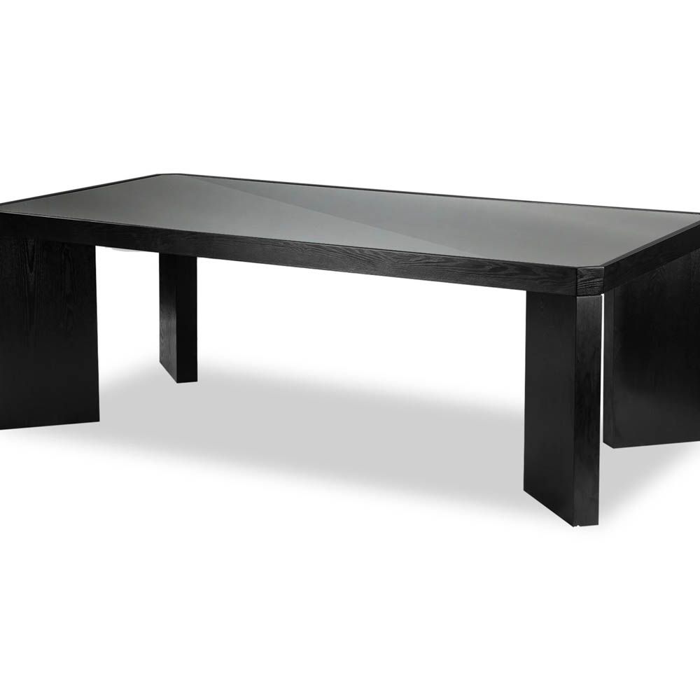 Wide legged dining table in black wood finish with glass top