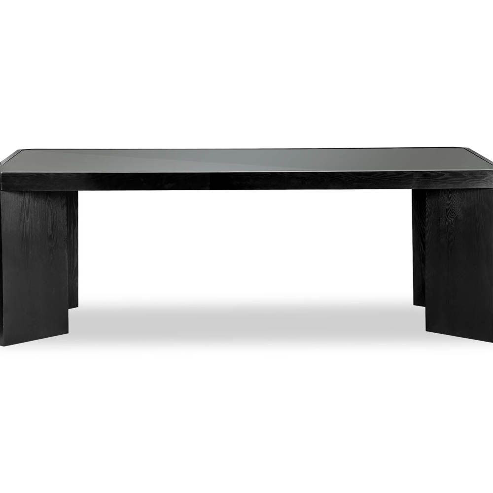 Wide legged dining table in black wood finish with glass top