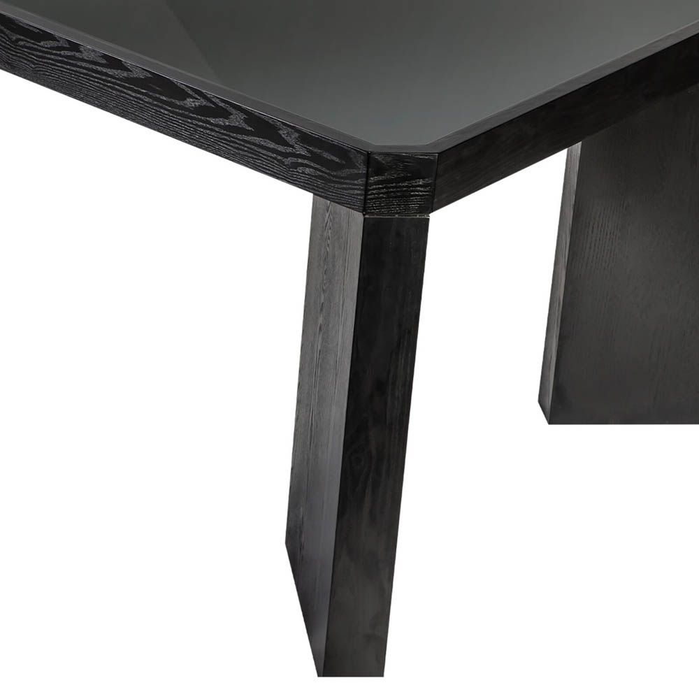 Wide legged dining table in black wood finish with glass top