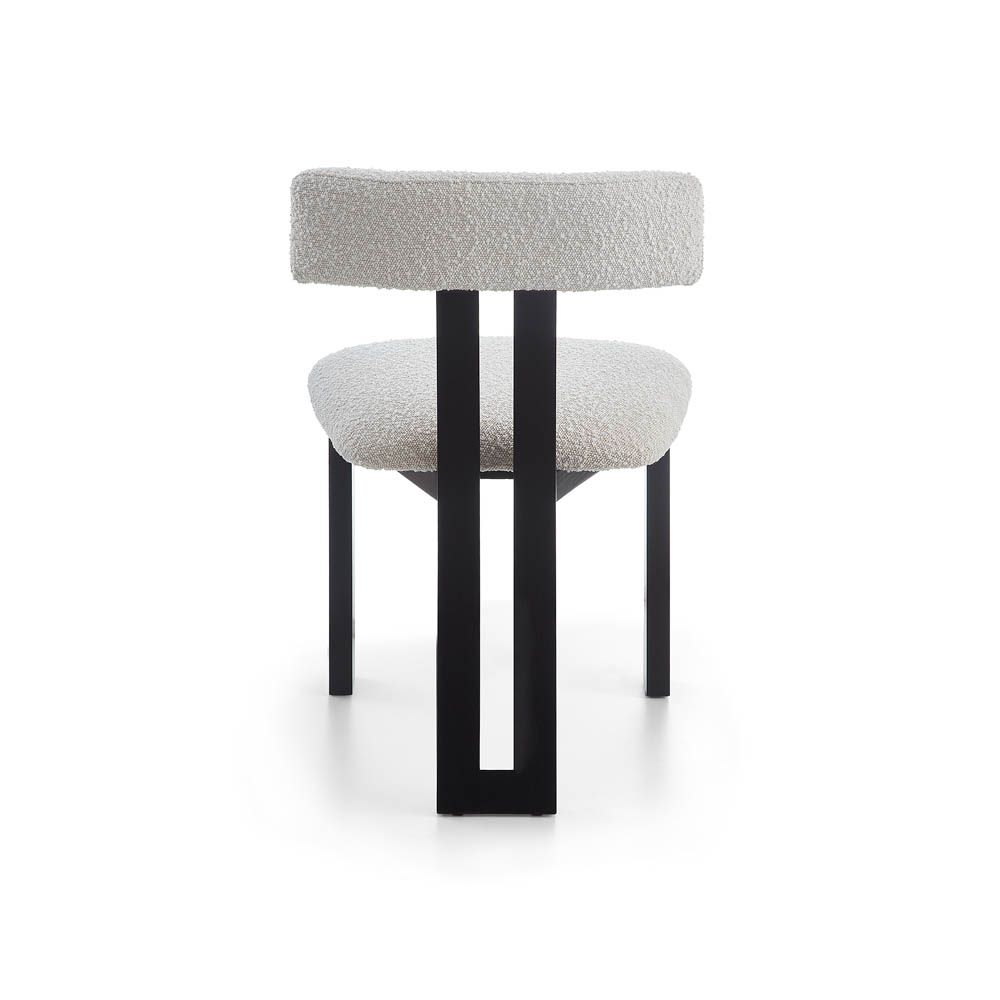 Elegant three-legged dining chair with boucle back rest and seat
