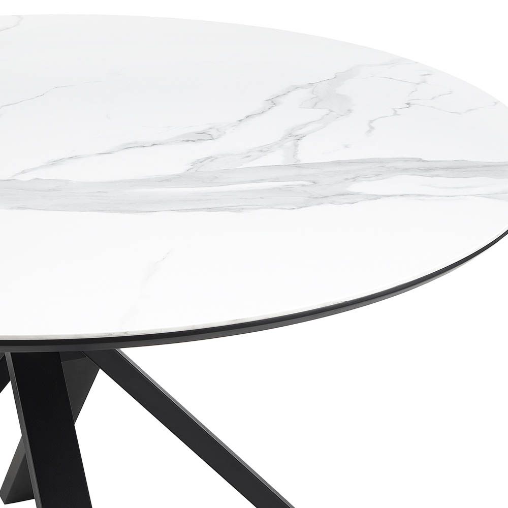 Round, white marble top dining table with dynamic crossed over legs
