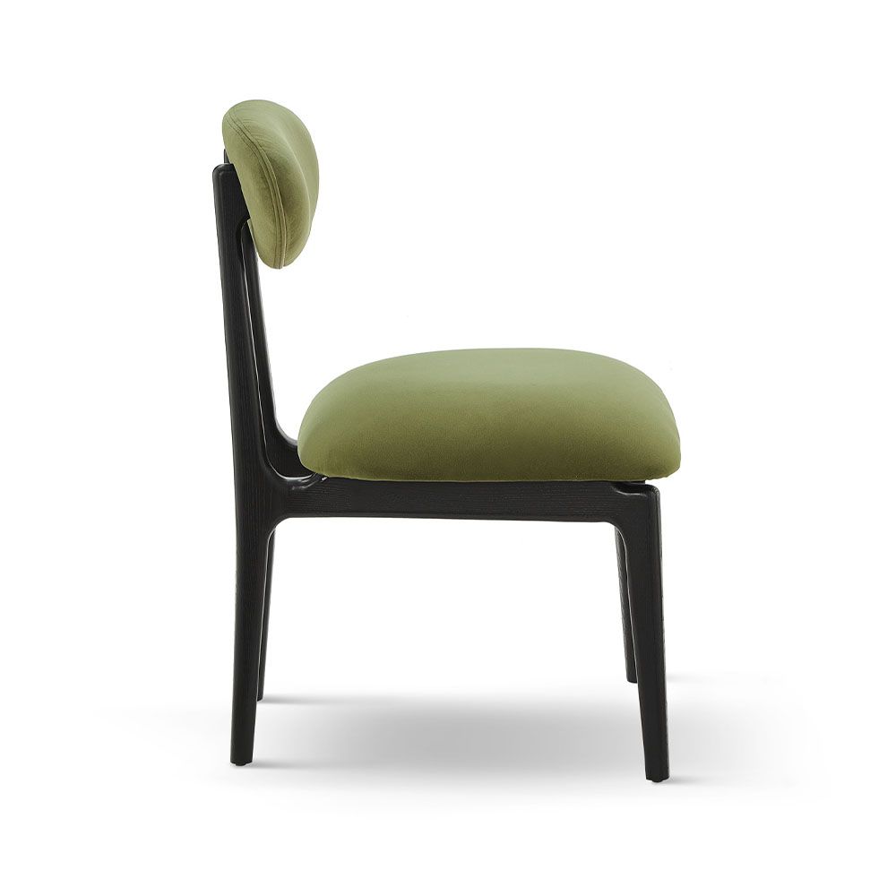 A statement dining chair with a gorgeous green upholstery