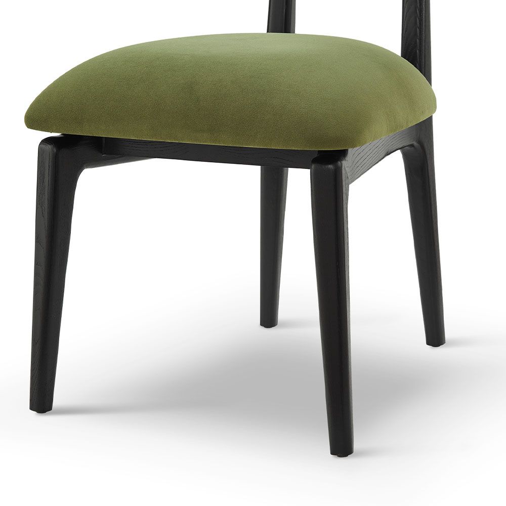 A statement dining chair with a gorgeous green upholstery