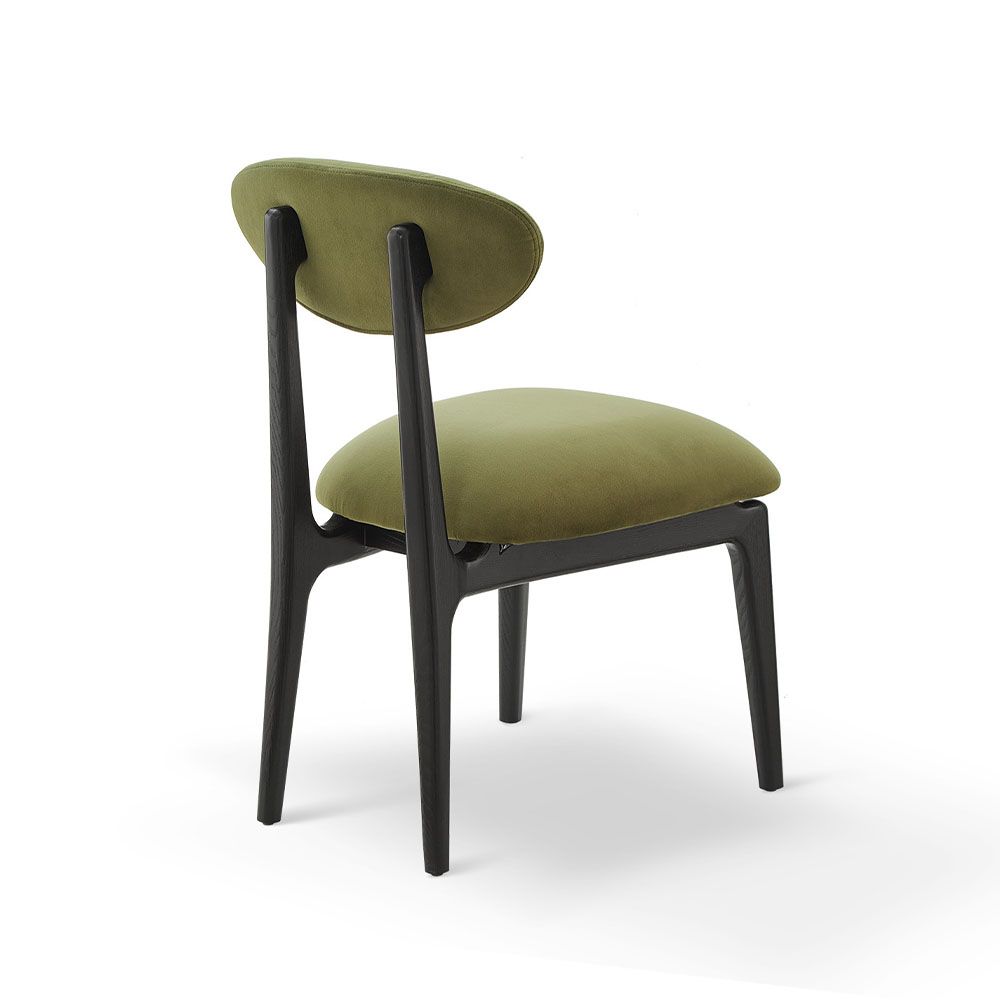 A statement dining chair with a gorgeous green upholstery