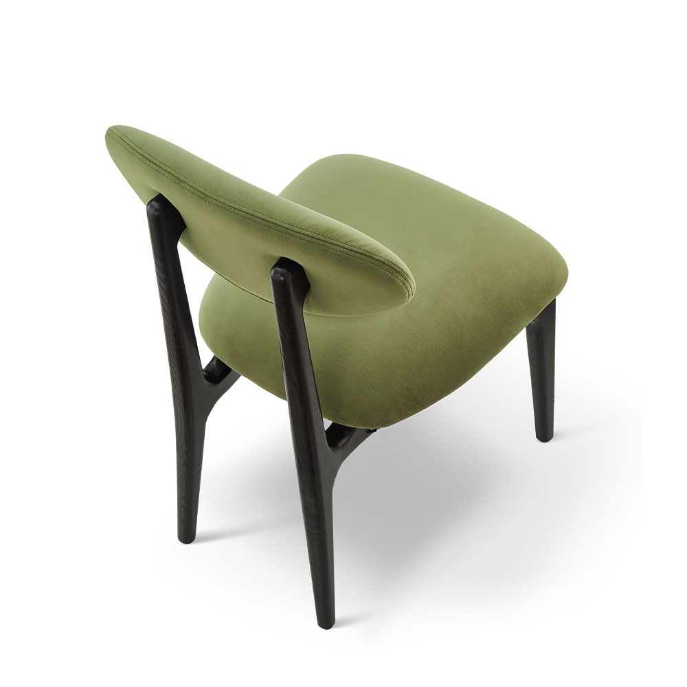 A statement dining chair with a gorgeous green upholstery