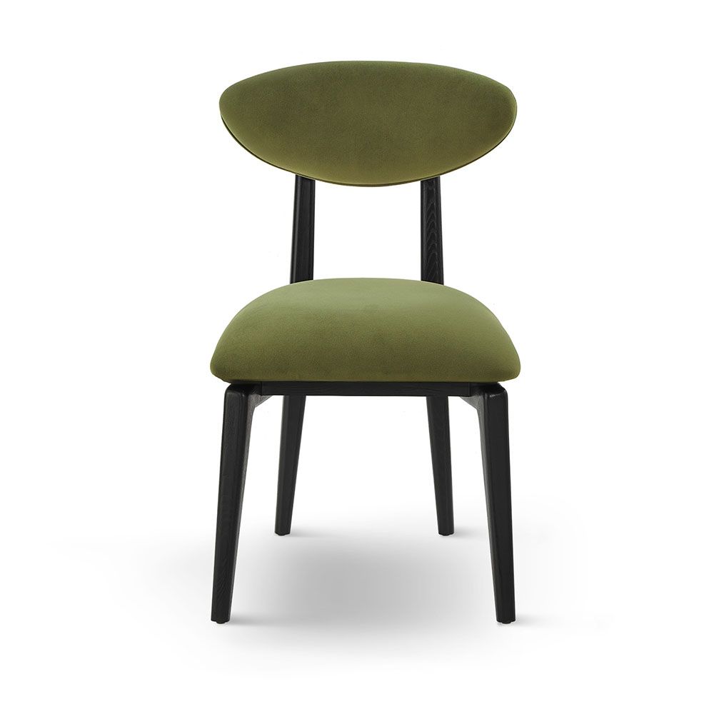 A statement dining chair with a gorgeous green upholstery