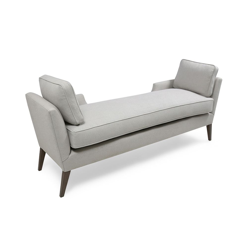 A stylish modern bench with cushions and wooden feet