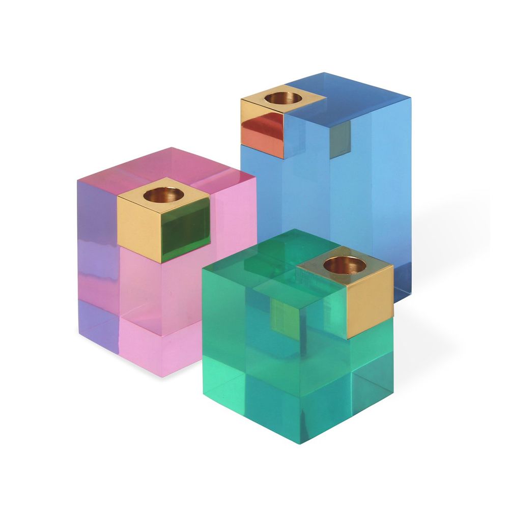 A luxuriously glamorous candleholder by Jonathan Adler with a solid pink acrylic block fitted with a solid brass corner candleholder