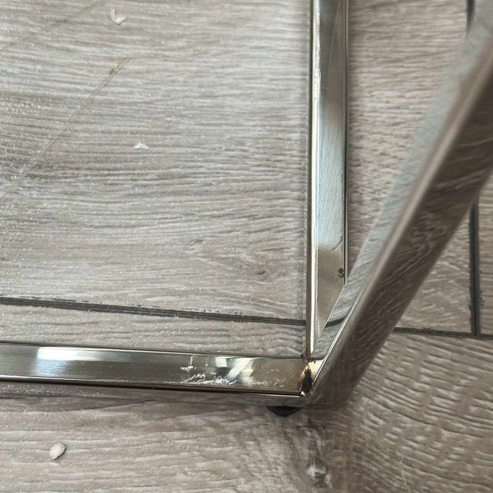 Polished stainless steel coffee table with tempered clear glass surface