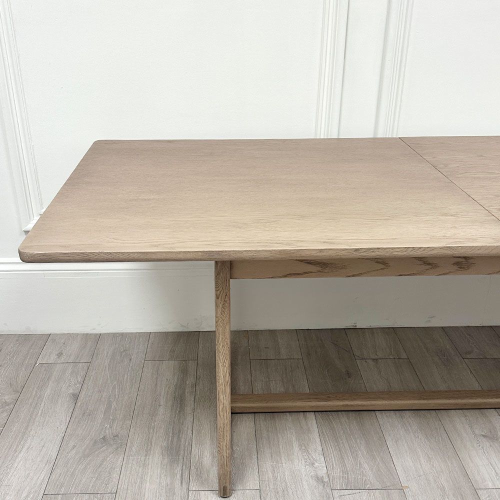 Wooden dining table with shaped underframe