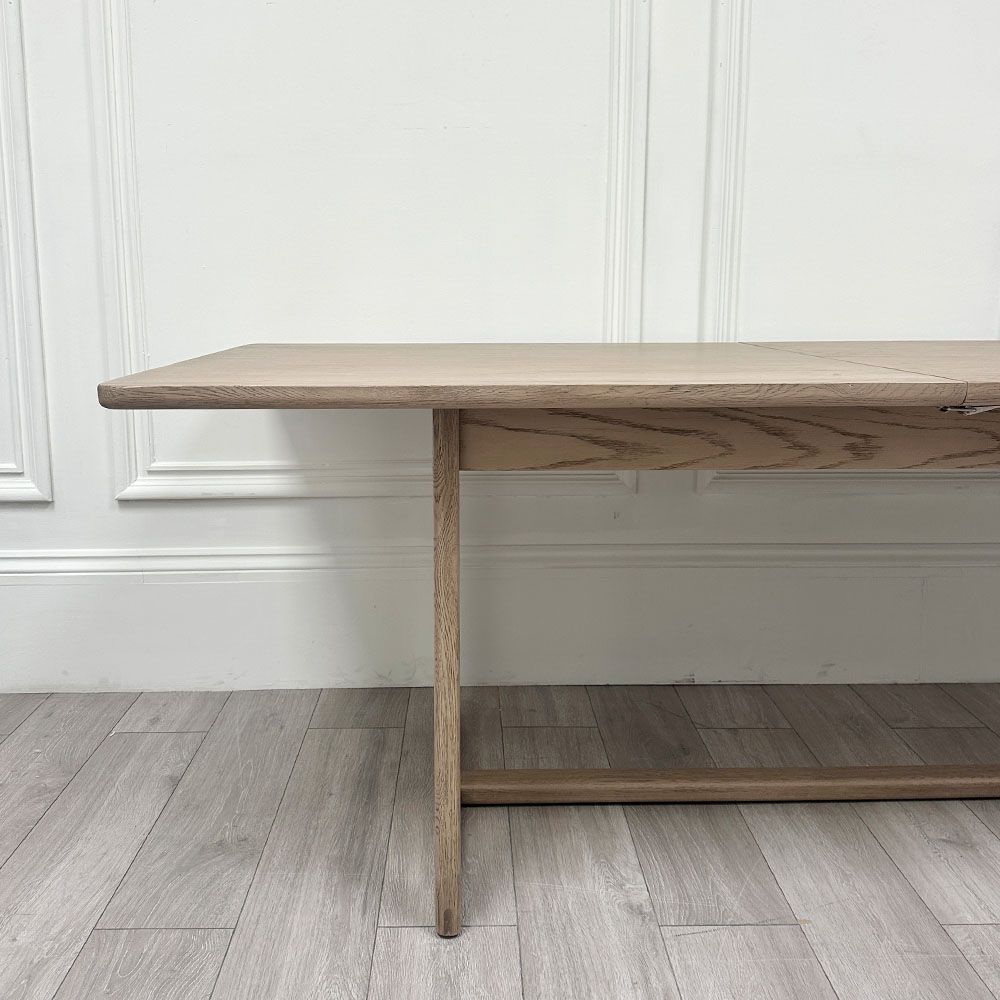 Wooden dining table with shaped underframe