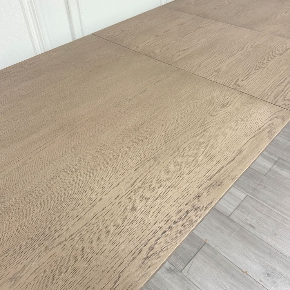 Wooden dining table with shaped underframe