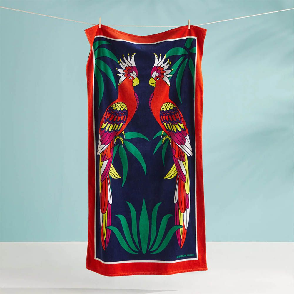 Dark blue beach towel with red border and two parrot design