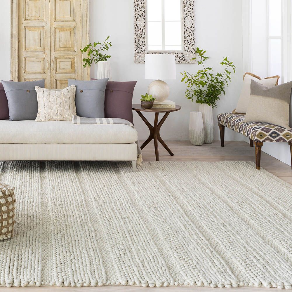 Ivory handwoven rug with loops, knots and basket weave patterns