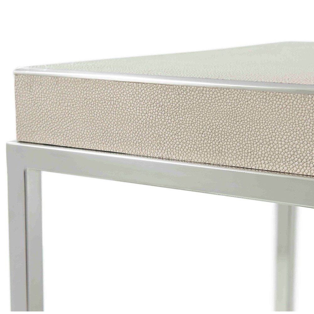A stylish side table with a shagreen leather top and cube-shaped, polished nickel base