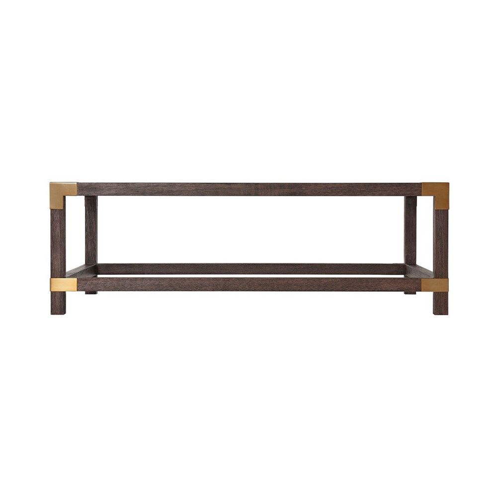 A stylish coffee table by Theodore Alexander with brushed brass corners