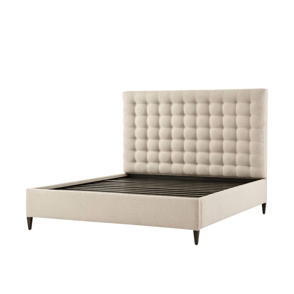 A sumptuous bed with a padded deep buttoned back and cream finish