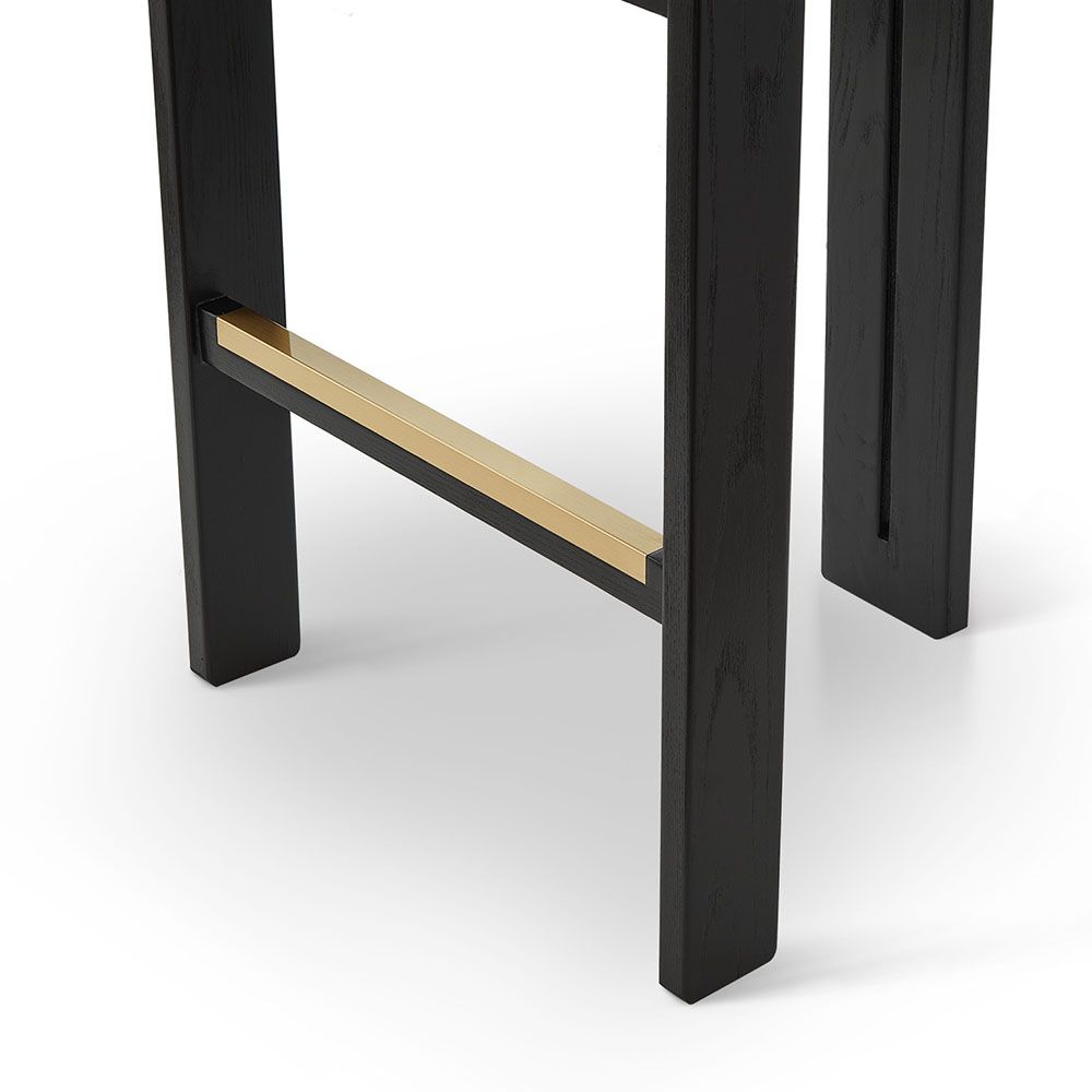 A luxury bar stool with a striking vibrant upholstery and brass detailing