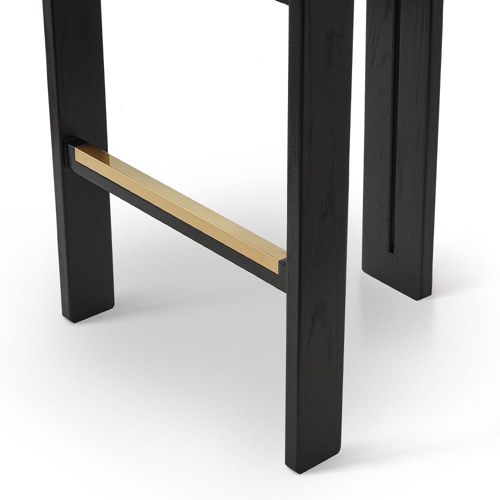 A luxury counter stool with a gorgeous grey upholstery and brass detailing