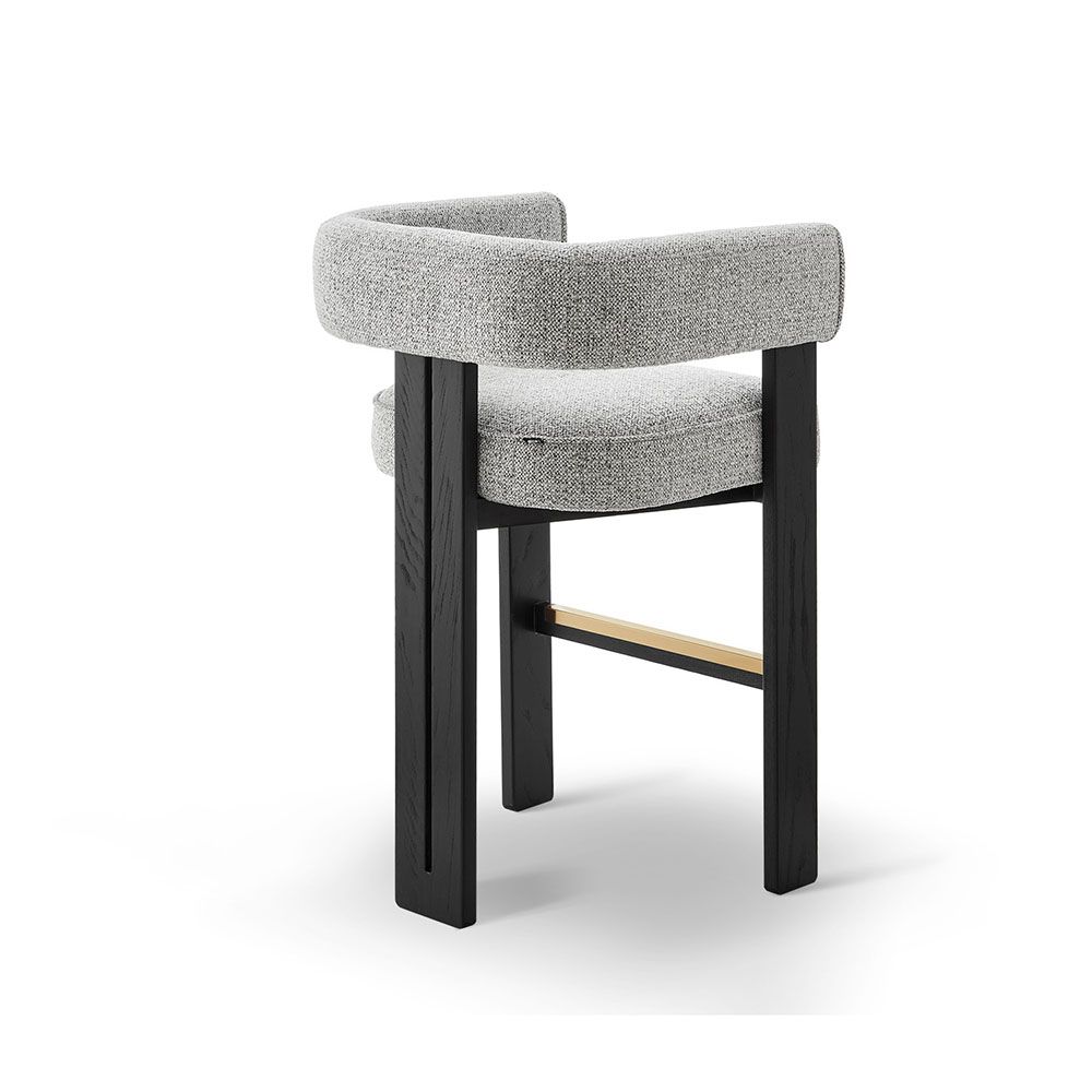 A luxury counter stool with a gorgeous grey upholstery and brass detailing