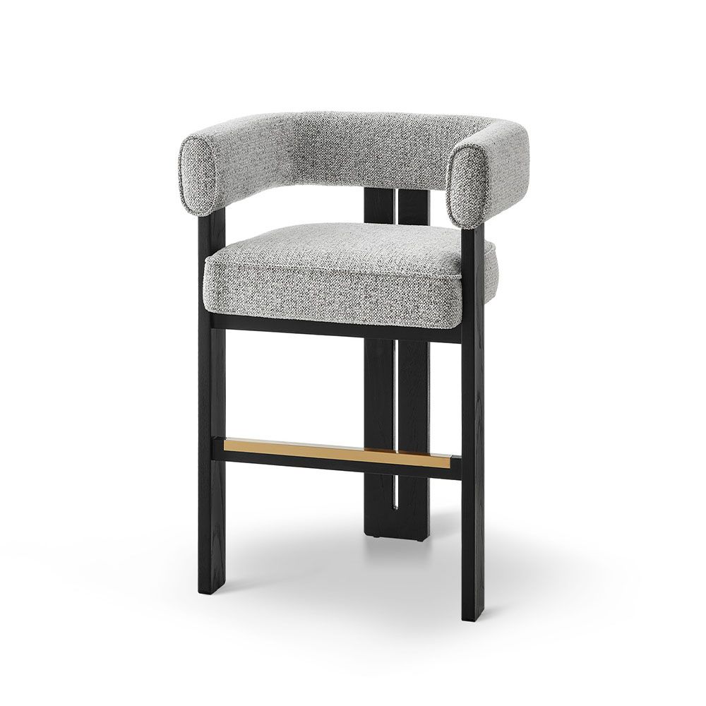 A luxury counter stool with a gorgeous grey upholstery and brass detailing