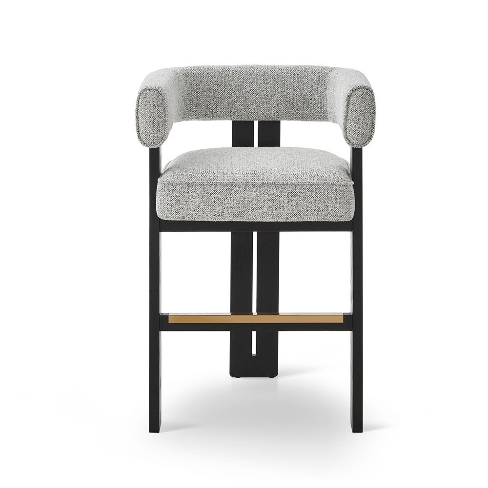 A luxury counter stool with a gorgeous grey upholstery and brass detailing