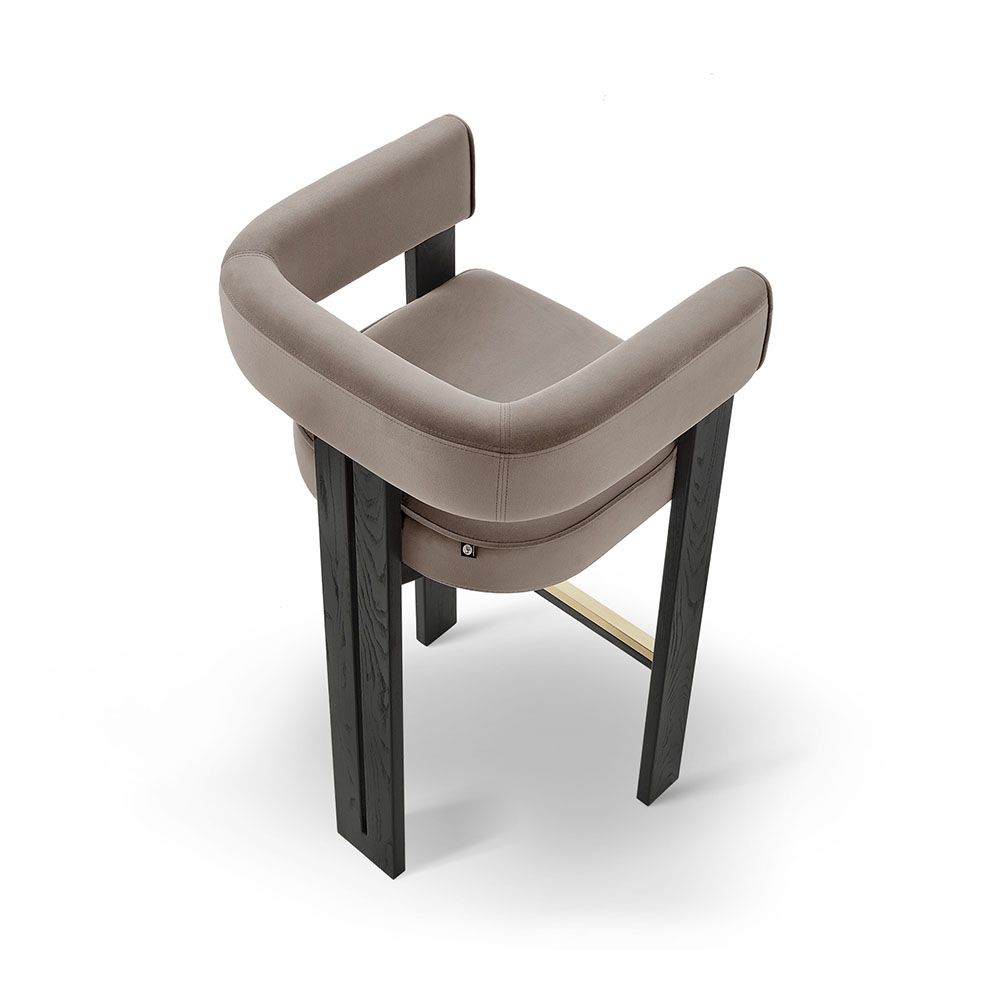 A luxury bar stool with a luxury grey velvet upholstery and brass detailing