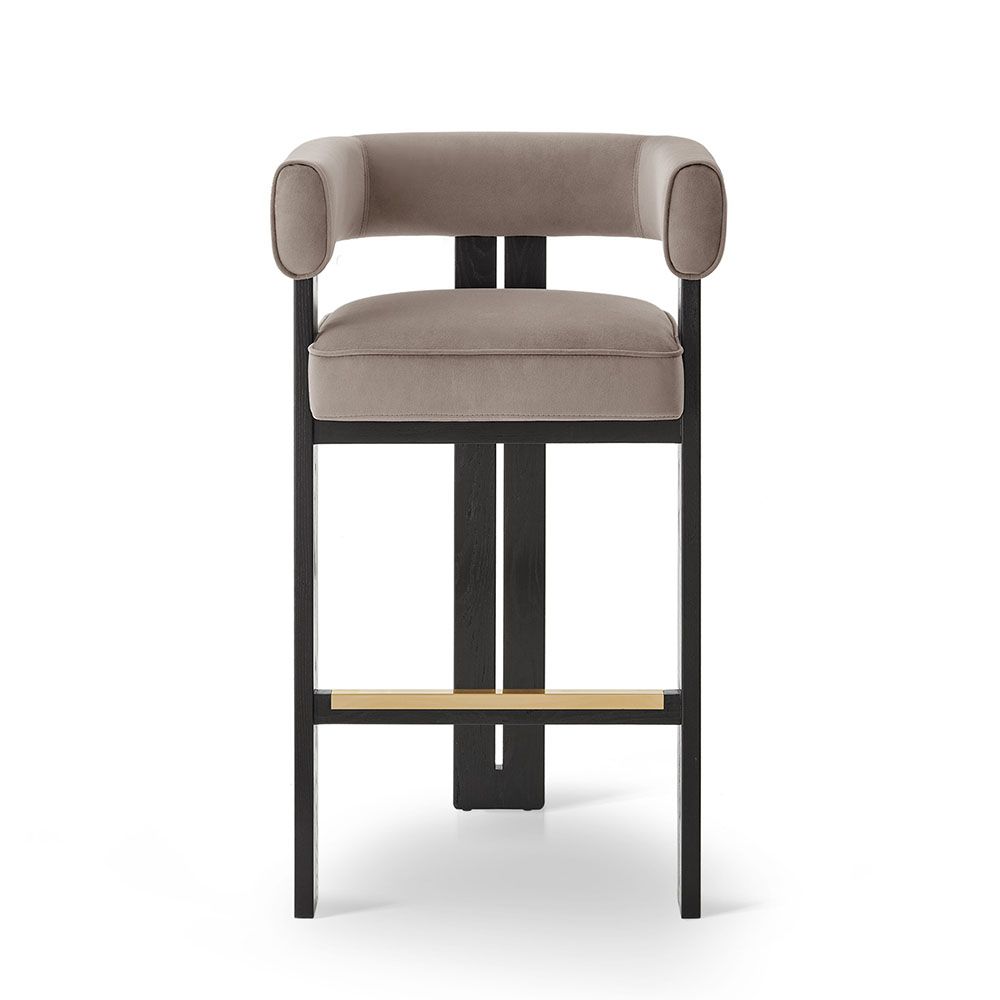 A luxury bar stool with a luxury grey velvet upholstery and brass detailing