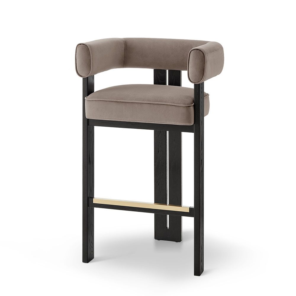 A luxury bar stool with a luxury grey velvet upholstery and brass detailing
