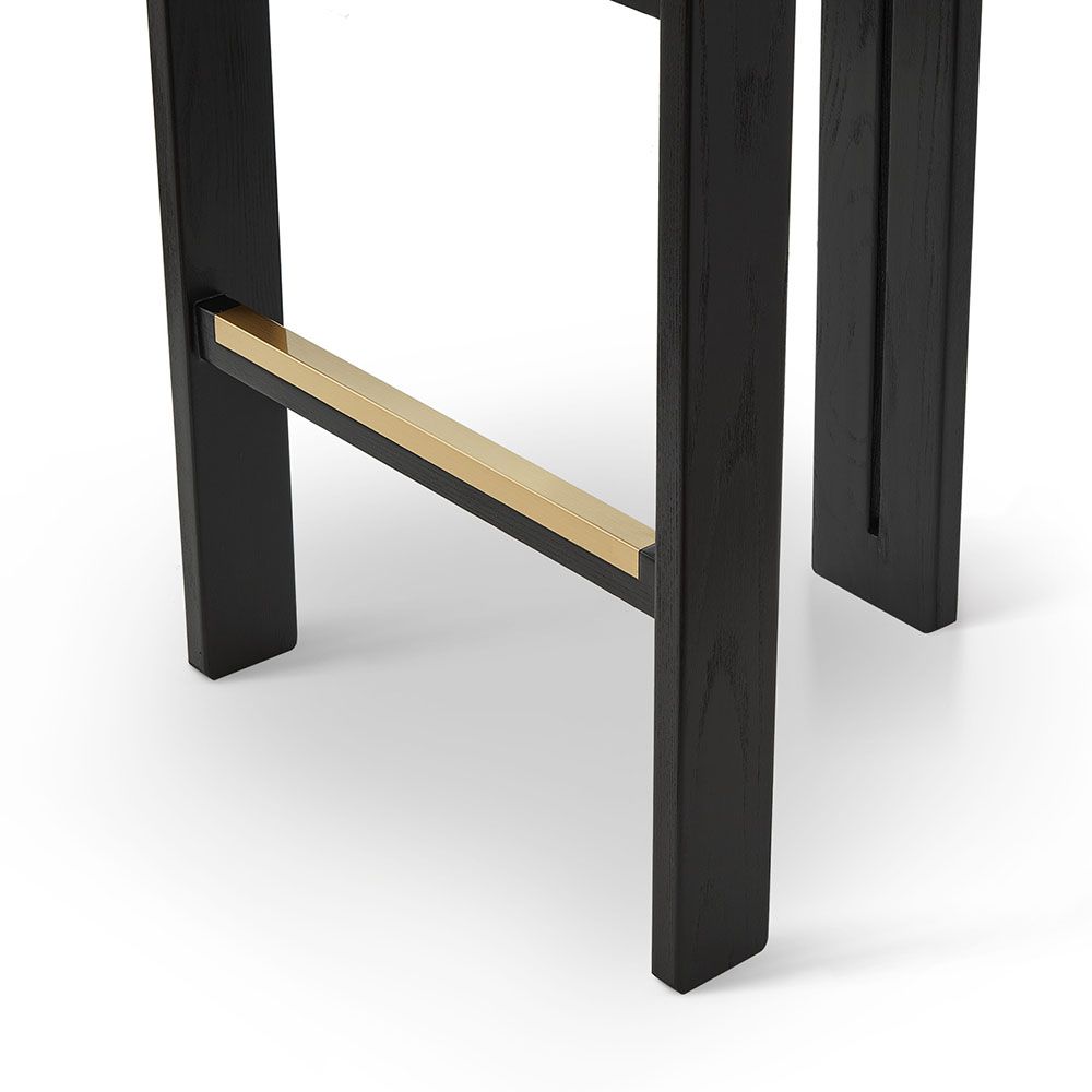 A luxury bar stool with a luxury grey velvet upholstery and brass detailing