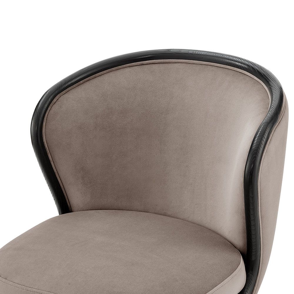 A luxury recycled velvet upholstered dining chair with a curved backrest