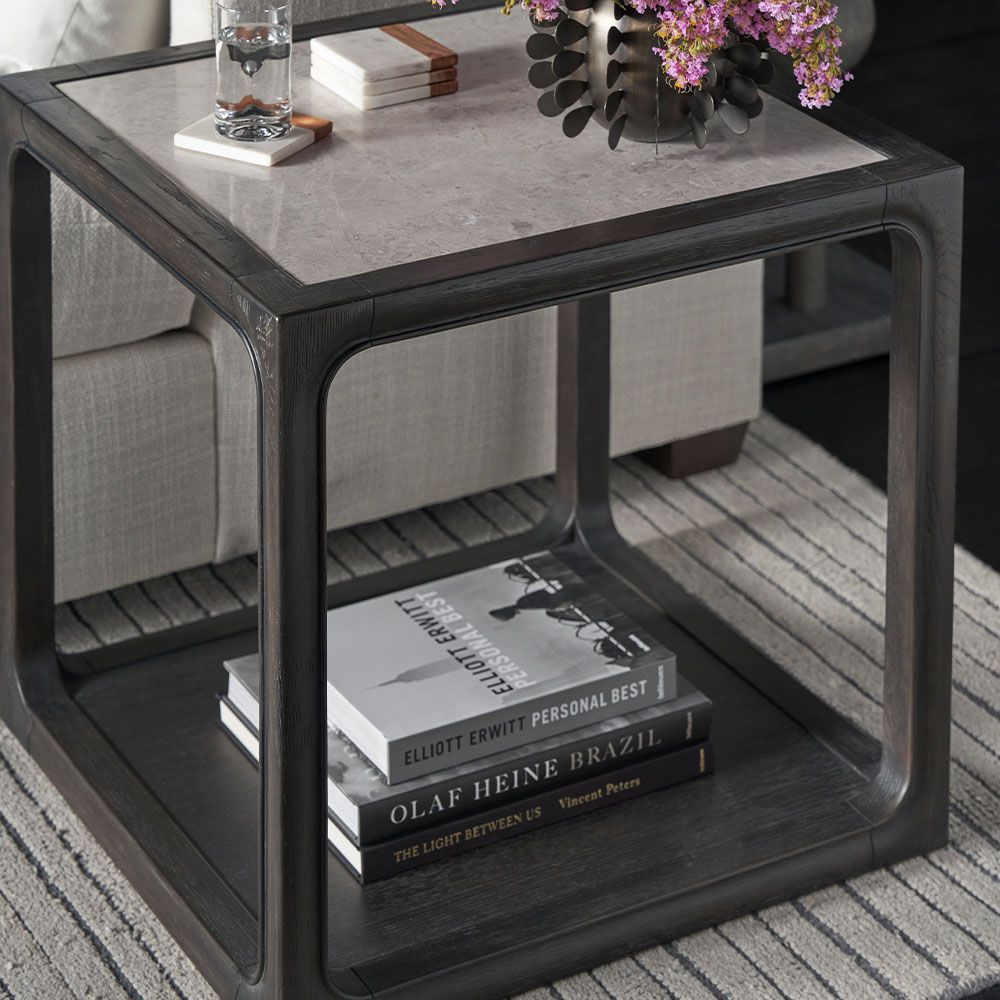 Side table with elegant marble details combining soft curves with hard lines