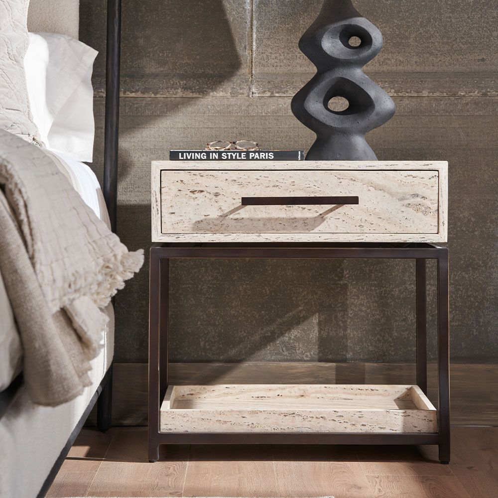 Sublime Travertine Bedside Table framed by gorgeous dark metalwork