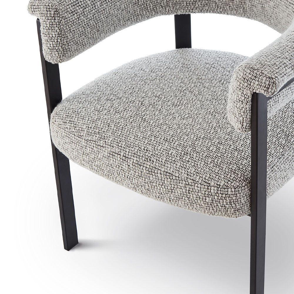 Elegant boucle upholstered dining chair in grey with black frame