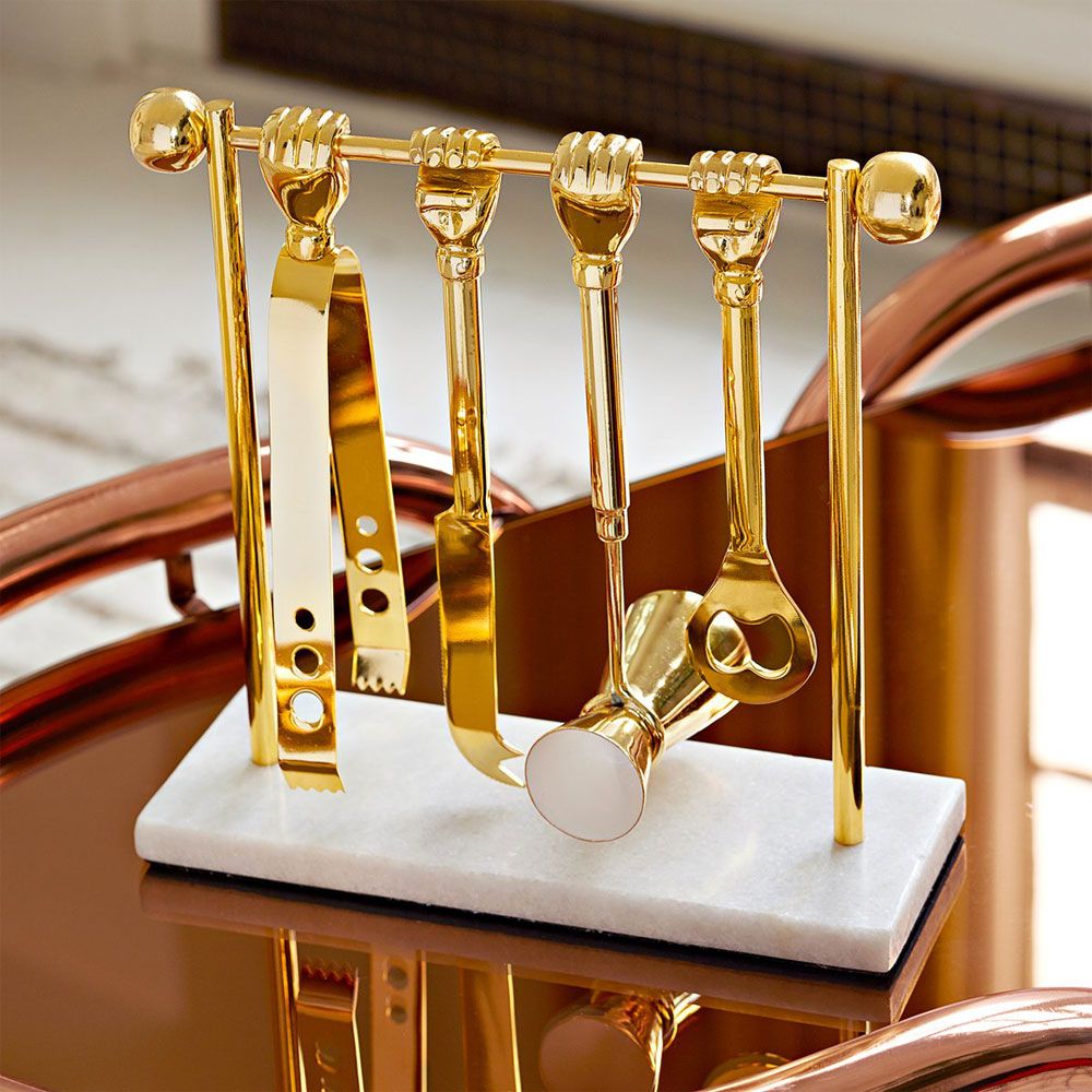 a luxurious solid brass barware set featuring ice tongs, bottle opener, double jigger, and knife