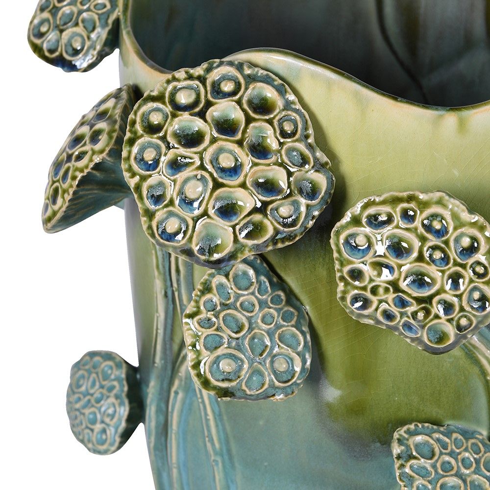 Green vase featuring lotus flowers