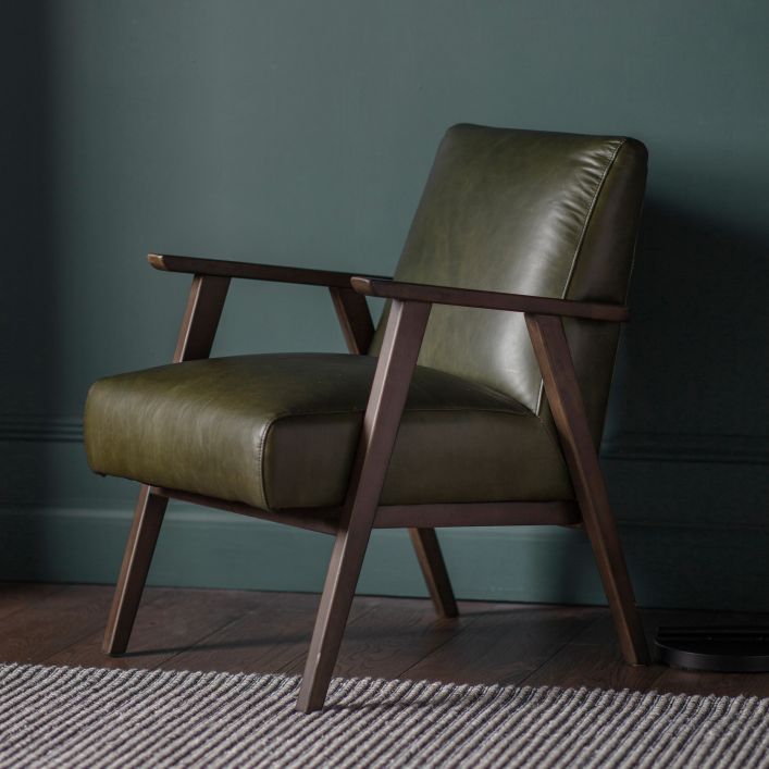 Mid-century style armchair with modern silhouette and green leather upholstery