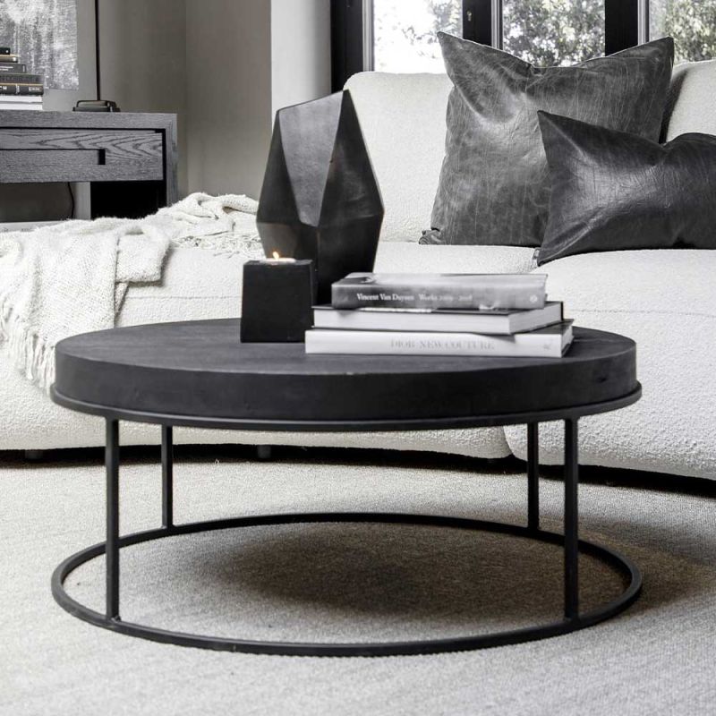 Round coffee table with black metal legs and black wooden tabletop