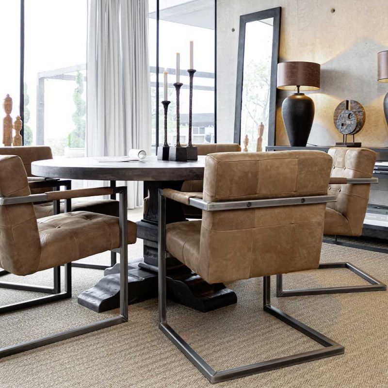 Round dining table with ornate base in dark brown