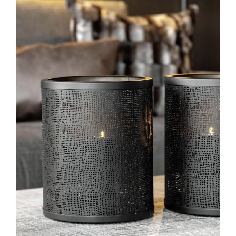 Understated black metal candle holders with small hole details