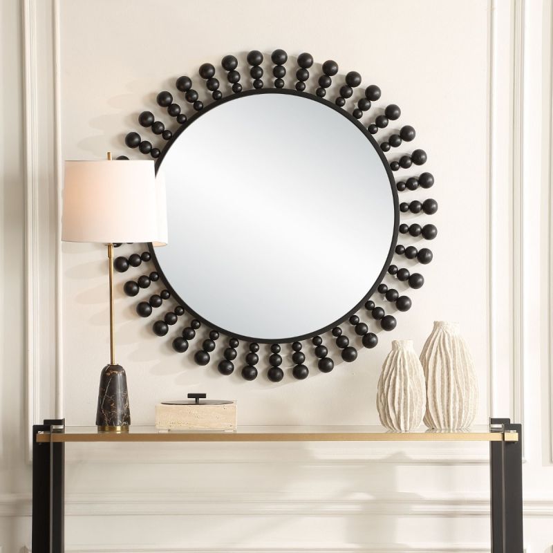 Elevate your decor with the Aziel Round Mirror—a stunning fusion of sleek satin black and modern sphere accents for a bold statement.